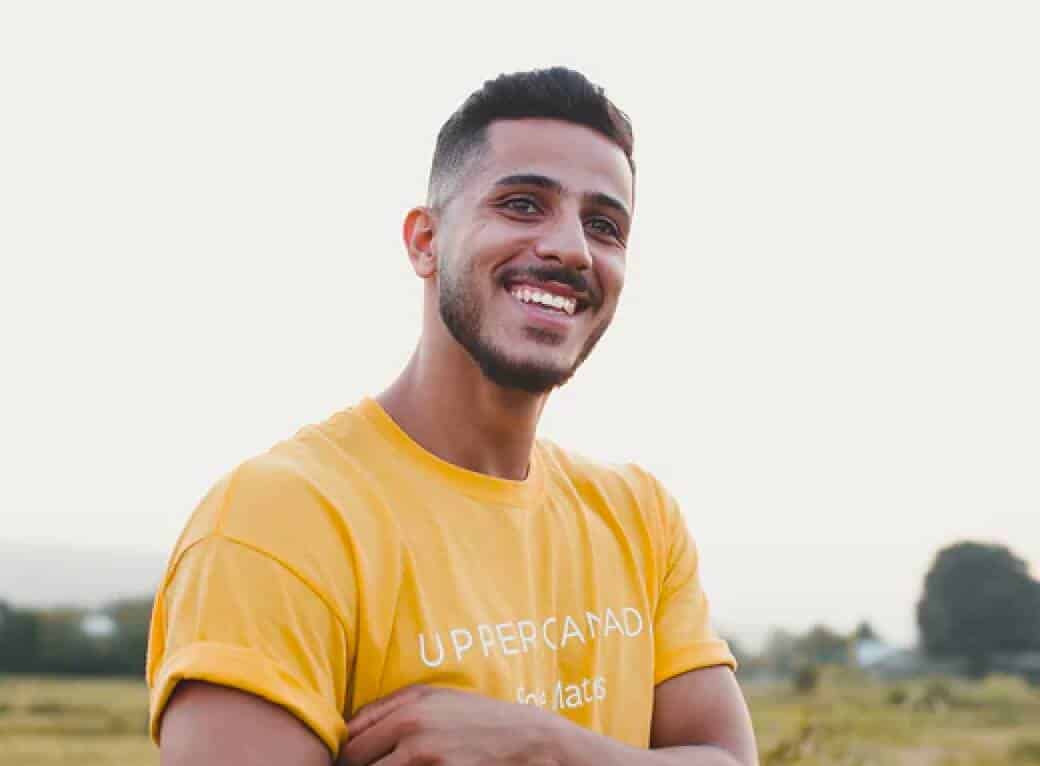 A portrait of young smiling man in yellow shirt